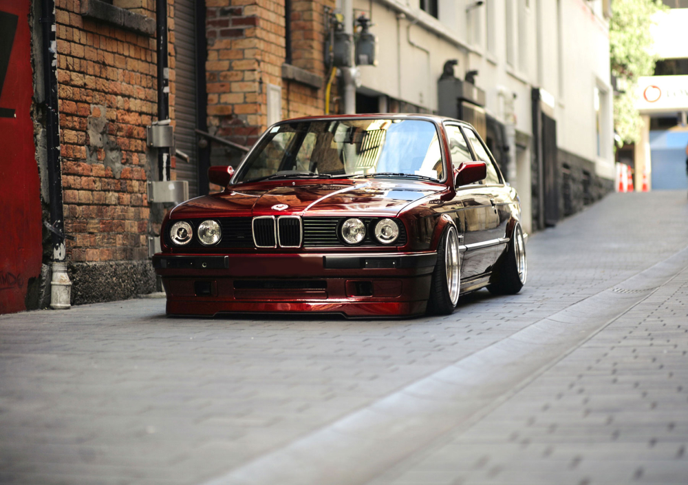 A modified classic BMW in a city lane